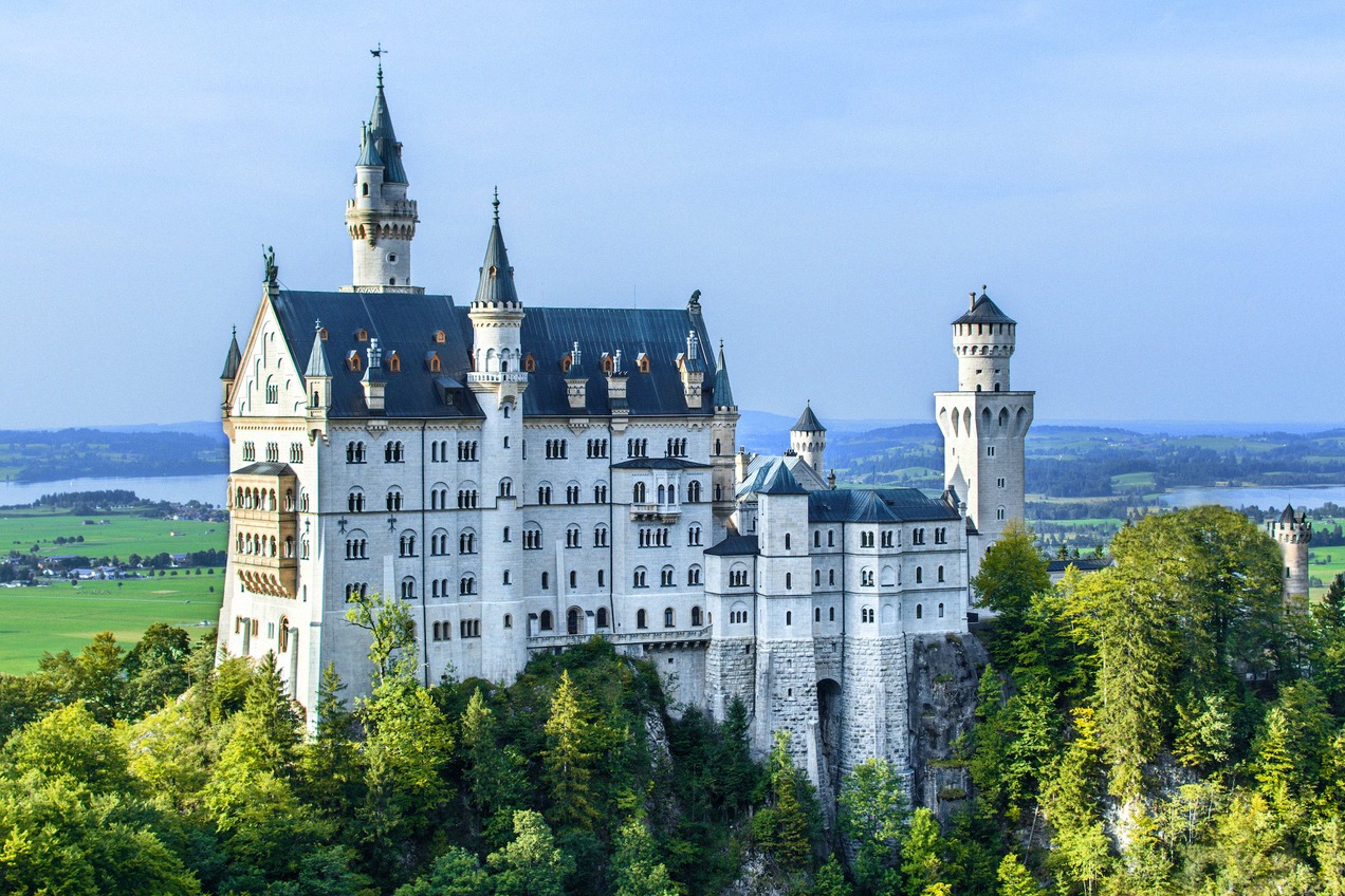 Neuschwanstein Castle on its wooded rock above the Bavarian alpine foreland